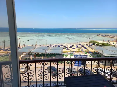 a balcony with a view of a beach and the ocean at شقة فندقية على البحر منطقة القيادات 2 in Hurghada