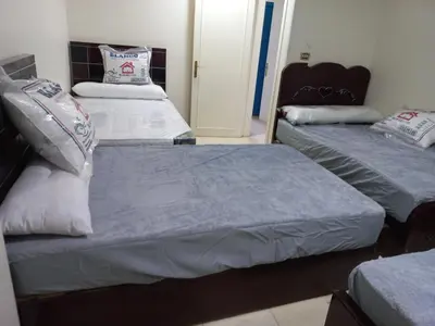 two beds in a room with two beds sidx sidx sidx at شقة فندقية على البحر منطقة القيادات 2 in Hurghada