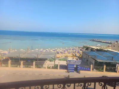 a view of a beach with umbrellas and the ocean at شقة فندقية على البحر منطقة القيادات 2 in Hurghada