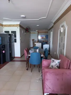 a living room with a pink couch and a table at شقة فندقية على البحر منطقة القيادات 2 in Hurghada