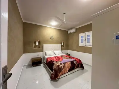 a bedroom with a bed in a room at Tuya House Luxor in Luxor