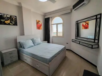 a bedroom with a bed and a window at Sea view one bedroom apartment in Hurghada Dreams in Hurghada