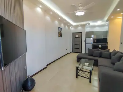 a living room with a couch and a tv at Sea view one bedroom apartment in Hurghada Dreams in Hurghada