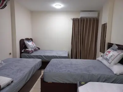 a room with two beds and a window at شقة فندقية على البحر مباشرا 2 in Hurghada