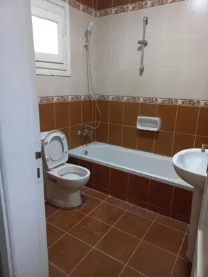 a bathroom with a toilet and a tub and a sink at شقة فندقية على البحر مباشرا 2 in Hurghada