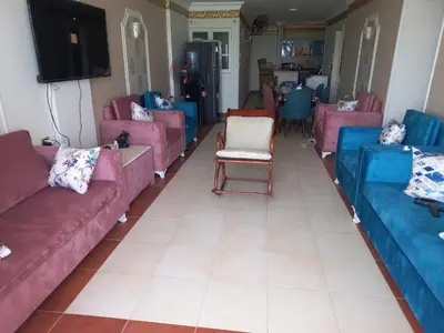 a living room with pink and blue couches at شقة فندقية على البحر مباشرا 2 in Hurghada