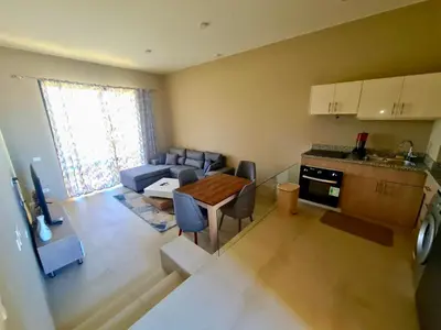 a kitchen and a living room with a couch and a table at Elgouna, Tawila island in Hurghada