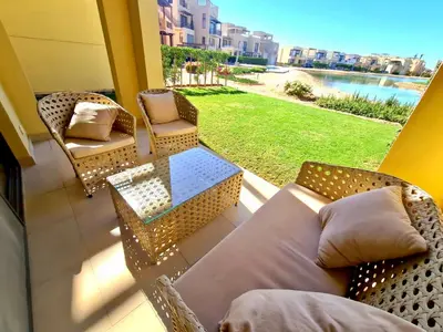 a balcony with a couch and chairs and a table at Elgouna, Tawila island in Hurghada