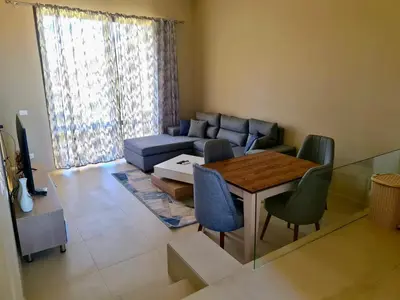 a living room with a couch and a table and chairs at Elgouna, Tawila island in Hurghada