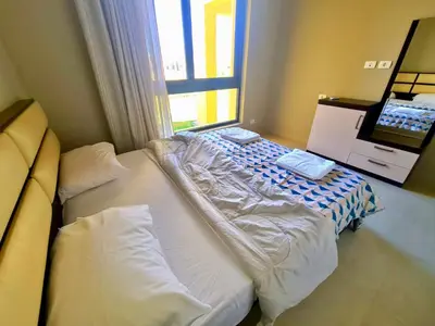 a large bed in a room with a window at Elgouna, Tawila island in Hurghada