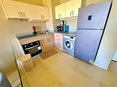 a kitchen with a refrigerator and a washing machine at Elgouna, Tawila island in Hurghada