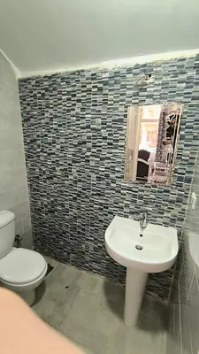 a bathroom with a toilet and a sink and a mirror at Paradise Hill 207 in Hurghada