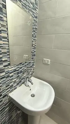 a bathroom with a white sink and a mirror at Paradise Hill 207 in Hurghada