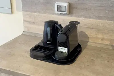 a black coffee maker sitting on the corner of a wall at Remarkable & Rare 2BDR Mangroovy Free Pool & Beach in Hurghada