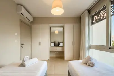 a bedroom with two beds and a window at Remarkable & Rare 2BDR Mangroovy Free Pool & Beach in Hurghada