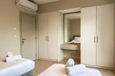 a bedroom with two beds and a mirror at Remarkable & Rare 2BDR Mangroovy Free Pool & Beach in Hurghada