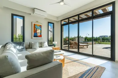 a living room with a couch and large windows at Modern luxury villa in SomaBay in Hurghada