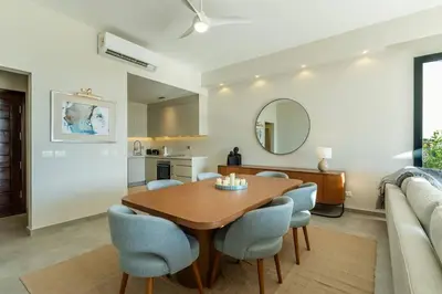 a dining room and living room with a table and chairs at Modern luxury villa in SomaBay in Hurghada