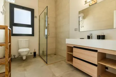a bathroom with a toilet and a sink and a shower at Modern luxury villa in SomaBay in Hurghada