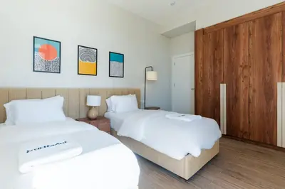 two beds in a room with white sheets at Modern luxury villa in SomaBay in Hurghada