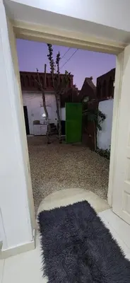 an open door with a black rug in a room at Little Private Palace in Luxor in Luxor