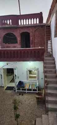 a brick building with a bench in front of it at Little Private Palace in Luxor in Luxor