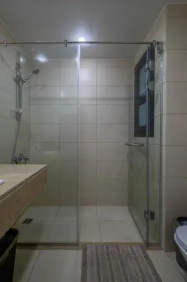 a bathroom with a shower with a glass door at Gouna Getaway in Hurghada