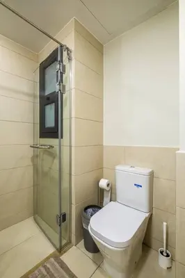 a bathroom with a toilet and a glass shower at Gouna Getaway in Hurghada