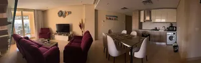 a kitchen and a living room with a table and chairs at El gouna mangrouovy in Hurghada