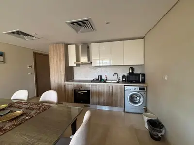 a kitchen with a table and a kitchen with a washing machine at El gouna mangrouovy in Hurghada