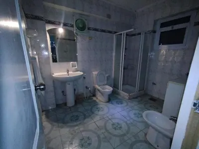 a bathroom with a sink and a toilet and a shower at جبل تقوق فيلا عبدالله محروس in Aswan