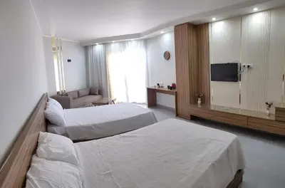 a hotel room with two beds and a television at Scandic resort hurghada in Hurghada