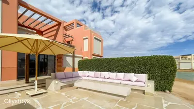 a couch sitting on a patio in front of a house at Ollystays Tawila 3BR Townhouse Shared Pool in Hurghada