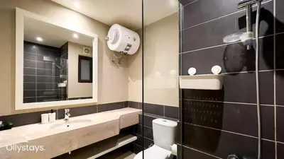 a bathroom with a sink and a toilet and a mirror at Ollystays Tawila 3BR Townhouse Shared Pool in Hurghada