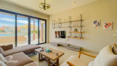 a living room with a couch and a table at Ollystays Tawila 3BR Townhouse Shared Pool in Hurghada