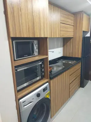 a kitchen with a washing machine and a microwave at Scandic Resort Hurghada, Sea View in Hurghada