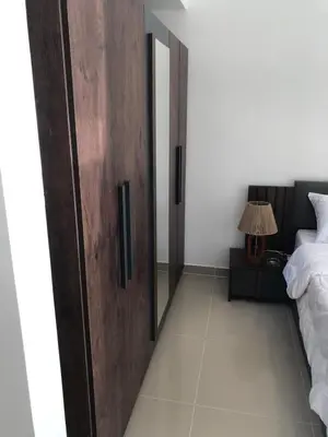 a bedroom with a wooden door next to a bed at Luxury stay in El Gouna