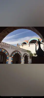 a tv screen with a picture of a building at Nuba life hostel in Najâ€˜ al MadÄbb