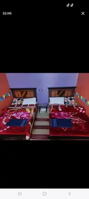 two beds sitting next to each other in a bedroom at Nuba life hostel in Najâ€˜ al MadÄbb