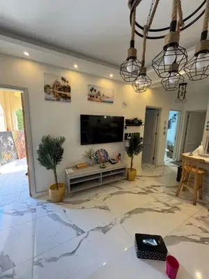 a living room with a flat screen tv on a wall at The getaway in Hurghada