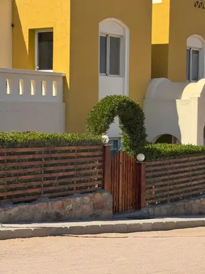 a wooden fence in front of a house at The getaway in Hurghada