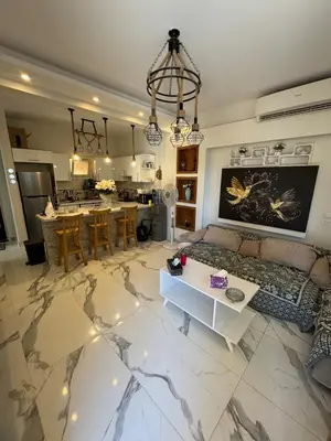 a living room with a couch and a table at The getaway in Hurghada