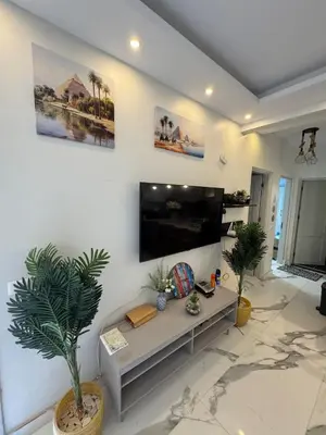 a living room with a large flat screen tv on a wall at The getaway in Hurghada