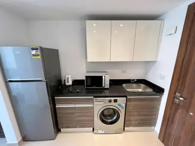 a kitchen with a refrigerator and a washing machine at Studio el Gouna holiday G cribs Compound in Hurghada