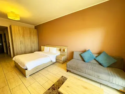 a bedroom with two beds and a couch at Aldau Heights in Hurghada
