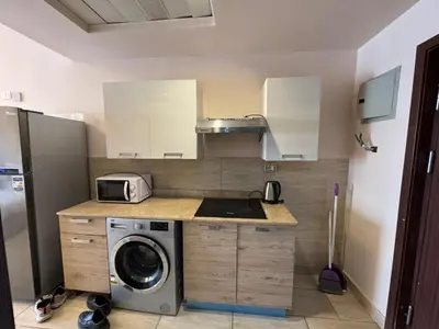 a kitchen with a sink and a washing machine at Aldau Heights in Hurghada