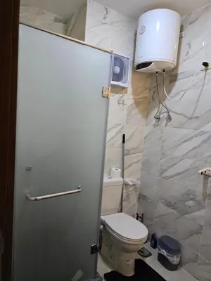 a bathroom with a toilet and a water heater at Taiba Golden Central Hurghada in Hurghada