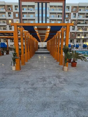 a hallway in a large apartment building with orange columns at Taiba Golden Central Hurghada in Hurghada