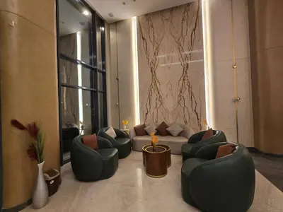 a living room with couches and chairs in a room at Taiba Golden Central Hurghada in Hurghada