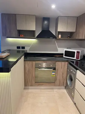 a kitchen with a stove and a microwave at Marina Beach Front 3 Br Duplex in Hurghada